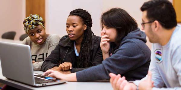 Photo of students working together in class